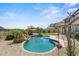 Beautiful backyard with a sparkling pool, desert landscaping, mature trees, and pergola at 21104 W Sage Hill Rd, Buckeye, AZ 85396