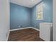 Room with a single window, wood-look flooring and a freezer unit at 21104 W Sage Hill Rd, Buckeye, AZ 85396