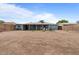 Large, sunny backyard showcasing desert landscaping, block fencing, and a classic blue house with white trim at 2144 W 1St Pl, Mesa, AZ 85201