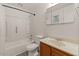 Well-lit bathroom with white tiled shower and neutral-toned vanity at 2144 W 1St Pl, Mesa, AZ 85201