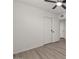 Clean bedroom featuring hardwood floors and closet doors at 2144 W 1St Pl, Mesa, AZ 85201