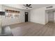 Bright living room with a ceiling fan, window, and new flooring at 2144 W 1St Pl, Mesa, AZ 85201