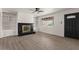 Bright living room with modern fireplace, built-in shelving, and updated flooring at 2144 W 1St Pl, Mesa, AZ 85201