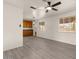 Open-concept living room with natural light, new floors, and a ceiling fan at 2144 W 1St Pl, Mesa, AZ 85201