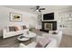 Cozy living room with modern decor, fireplace, and built-in shelving at 2144 W 1St Pl, Mesa, AZ 85201