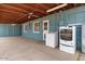 Covered patio featuring washer, dryer, and ceiling fans at 2144 W 1St Pl, Mesa, AZ 85201