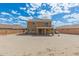 View of back exterior featuring a balcony and open yard space with a lush blue sky at 21972 W Pima St, Buckeye, AZ 85326