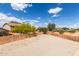 Expansive backyard with block wall and mature trees, perfect for outdoor activities at 21972 W Pima St, Buckeye, AZ 85326