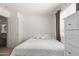 Bright bedroom with a white walls, minimalist decor, and natural light from the window at 21972 W Pima St, Buckeye, AZ 85326