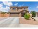 Charming two-story home featuring a two-car garage and a well-maintained, low-maintenance desert-landscaped front yard at 21972 W Pima St, Buckeye, AZ 85326