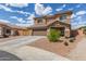Charming two-story home featuring a two-car garage and a well-maintained, low-maintenance desert-landscaped front yard at 21972 W Pima St, Buckeye, AZ 85326
