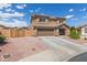 Charming two-story home featuring a two-car garage and a well-maintained, low-maintenance desert-landscaped front yard at 21972 W Pima St, Buckeye, AZ 85326