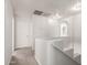 Bright hallway with white walls and neutral carpet leads to various rooms in the home at 21972 W Pima St, Buckeye, AZ 85326