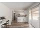 Open-concept kitchen featuring white cabinets, stainless steel appliances, wood floors and sliding glass doors at 21972 W Pima St, Buckeye, AZ 85326