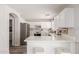 Modern kitchen featuring white cabinets, stainless steel appliances, light countertops and an island at 21972 W Pima St, Buckeye, AZ 85326