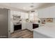Bright kitchen with white cabinets, stainless steel appliances, and a stylish countertop at 21972 W Pima St, Buckeye, AZ 85326