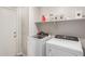 Functional laundry room with modern appliances and storage, ensuring convenience at 21972 W Pima St, Buckeye, AZ 85326