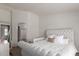 Spacious main bedroom featuring a queen-sized bed, white tufted headboard, and an en-suite bathroom at 21972 W Pima St, Buckeye, AZ 85326