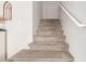 Carpeted stairs leading to the upper level, with white walls and handrail at 21972 W Pima St, Buckeye, AZ 85326