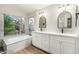 Beautiful bathroom with a tub and dual vanities at 236 W Calle Monte Vista Dr, Tempe, AZ 85284