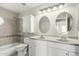 Bathroom featuring double sinks and bathtub with tiled walls at 236 W Calle Monte Vista Dr, Tempe, AZ 85284