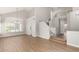 Open living room featuring light-toned walls, wood floors, a large chandelier, and stairway access at 236 W Calle Monte Vista Dr, Tempe, AZ 85284
