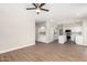Open-concept living space adjacent to a kitchen featuring wood floors and natural light at 236 W Calle Monte Vista Dr, Tempe, AZ 85284