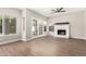 Comfortable living room featuring a fireplace, wood floors, and French doors leading to the backyard at 236 W Calle Monte Vista Dr, Tempe, AZ 85284