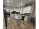 Bright kitchen with granite countertops, white cabinets, stainless steel appliances, and a central island at 2670 S Dragoon Dr, Chandler, AZ 85286