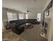 Spacious living room with a large sectional sofa, ceiling fan, fireplace, and plenty of natural light at 2670 S Dragoon Dr, Chandler, AZ 85286