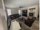 Large living room with a comfortable sectional sofa, fireplace, and ample natural light from multiple windows at 2670 S Dragoon Dr, Chandler, AZ 85286