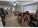 Bright living room with carpet flooring, ceiling fan, and large windows, ready for your personal touch at 2670 S Dragoon Dr, Chandler, AZ 85286