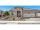 Charming home featuring desert landscaping, a tile roof, and an attached two-car garage at 26915 W Piute Ave, Buckeye, AZ 85396