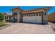 View of the garage featuring a paved driveway and white garage door with decorative windows at 26915 W Piute Ave, Buckeye, AZ 85396