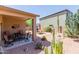 Spacious backyard with covered patio, desert landscaping, and plenty of room for entertaining at 28834 N Spur Dr, San Tan Valley, AZ 85143