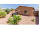 A well-maintained backyard featuring desert landscaping and a covered patio with an outdoor dining set at 28834 N Spur Dr, San Tan Valley, AZ 85143