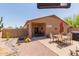 Backyard with covered patio, outdoor seating area, and desert landscaping at 28834 N Spur Dr, San Tan Valley, AZ 85143