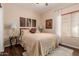 Inviting bedroom with a queen bed, warm neutral tones, decorative art, and a large window for natural light at 28834 N Spur Dr, San Tan Valley, AZ 85143