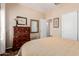 Bedroom with dresser and mirror, soft lighting, and a view into other rooms through an open door at 28834 N Spur Dr, San Tan Valley, AZ 85143