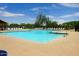 A large community pool surrounded by lounge chairs and lush landscaping, perfect for relaxation at 28834 N Spur Dr, San Tan Valley, AZ 85143