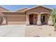 Attractive single-story home features a two car garage, a neutral stucco, and low-maintenance desert landscaping at 28834 N Spur Dr, San Tan Valley, AZ 85143