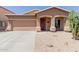 Charming single story home with a two car garage, neutral colored stucco, and xeriscaping for low maintenance at 28834 N Spur Dr, San Tan Valley, AZ 85143