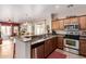 This open concept kitchen has granite counters, stainless appliances, and connects to the dining and living areas at 28834 N Spur Dr, San Tan Valley, AZ 85143