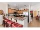 Gourmet kitchen with breakfast bar, granite counters, and stainless steel appliances providing ample seating and preparation space at 28834 N Spur Dr, San Tan Valley, AZ 85143
