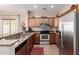 This kitchen features granite counters, stainless appliances and plenty of storage in the wood cabinets at 28834 N Spur Dr, San Tan Valley, AZ 85143