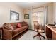 Comfortable office space with a brown futon, wooden desk, and natural light from the window at 28834 N Spur Dr, San Tan Valley, AZ 85143