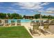 A beautiful swimming pool offers residents a relaxing oasis, complete with lounge chairs and a shaded area at 28834 N Spur Dr, San Tan Valley, AZ 85143