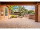 Spacious paved backyard with built-in grill, fire pit and lush landscaping at 28837 N 127Th Ave, Peoria, AZ 85383