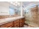 Bathroom featuring a double sink vanity and glass-enclosed shower with natural light at 28837 N 127Th Ave, Peoria, AZ 85383