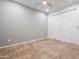 Bedroom with gray accent wall, tiled flooring, and double door closet at 28837 N 127Th Ave, Peoria, AZ 85383